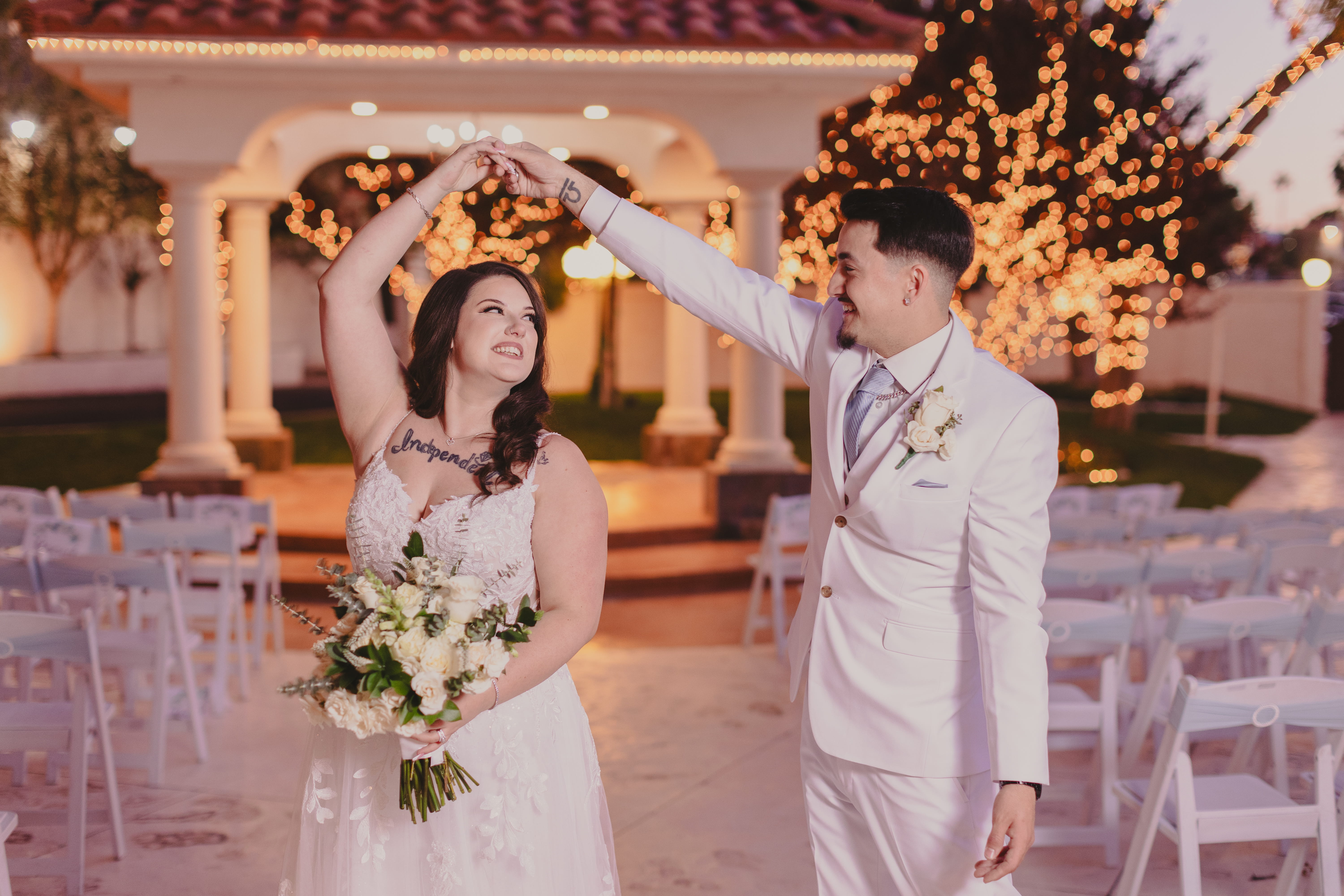 Bride and groom dancing under twinkling lights at a beautiful outdoor Las Vegas wedding ceremony space