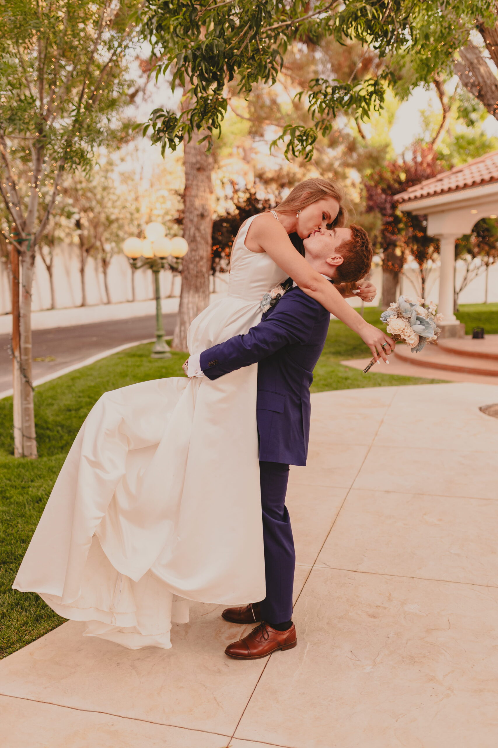 Bride and groom embracing in a romantic pose during a Las Vegas outdoor wedding photo session at Sunset Gardens
