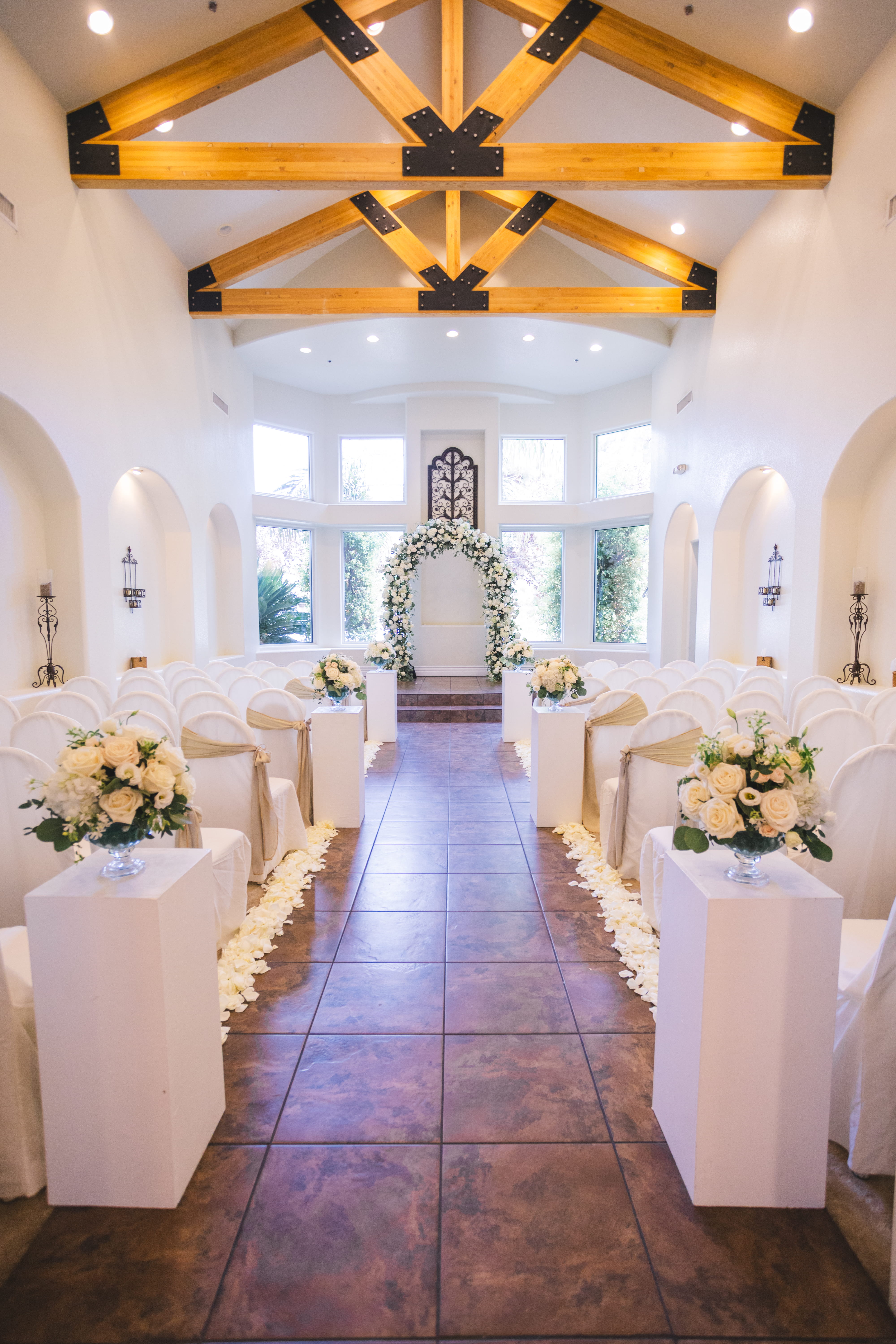 romantic Las Vegas wedding chapel aisle with rose petals and ceremony seating