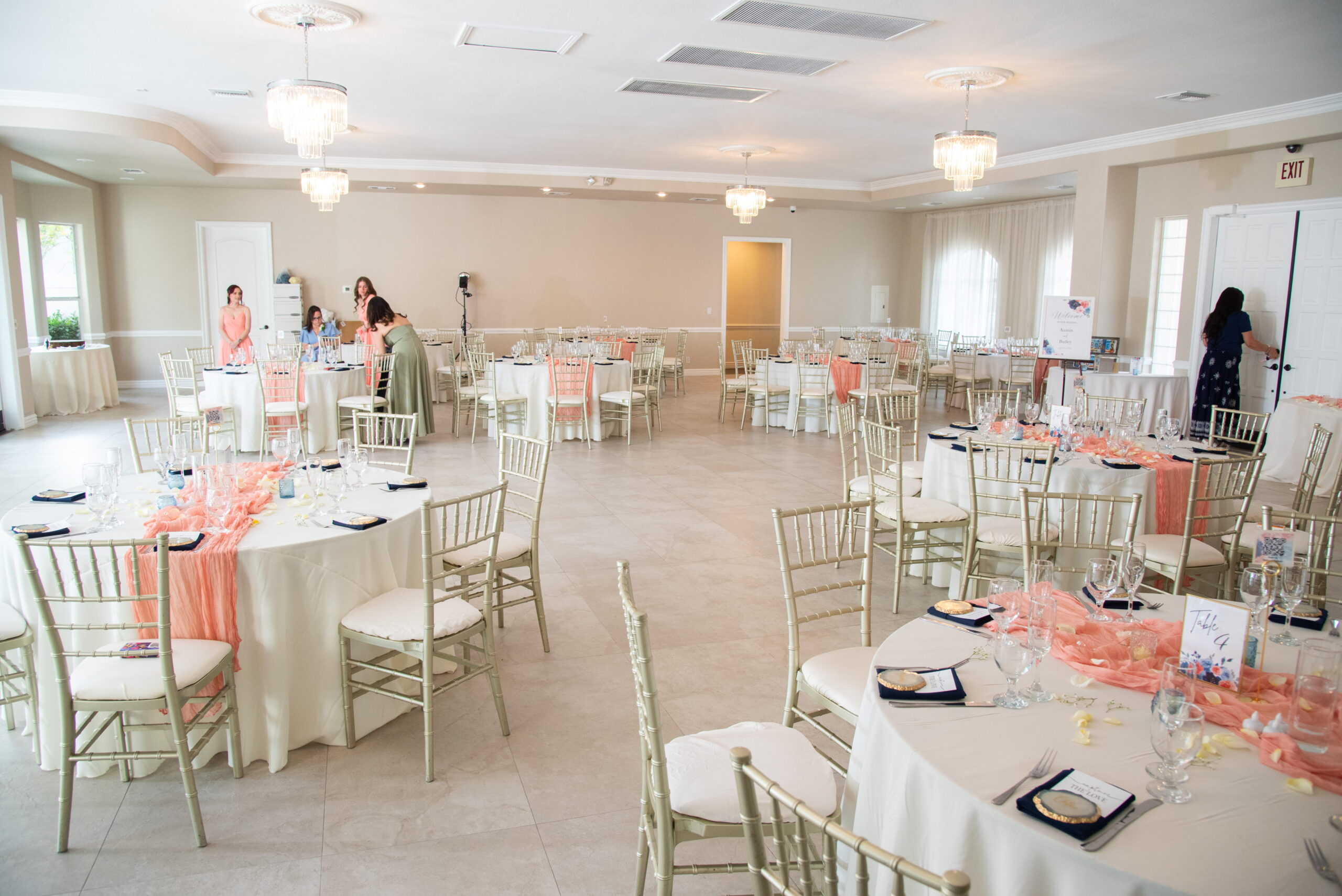 Wide view of Terrace Room reception setup with round tables and chandeliers Las Vegas