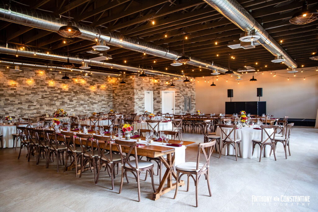 Indoor wedding reception setup in Las Vegas venue with long banquet tables and romantic overhead lighting