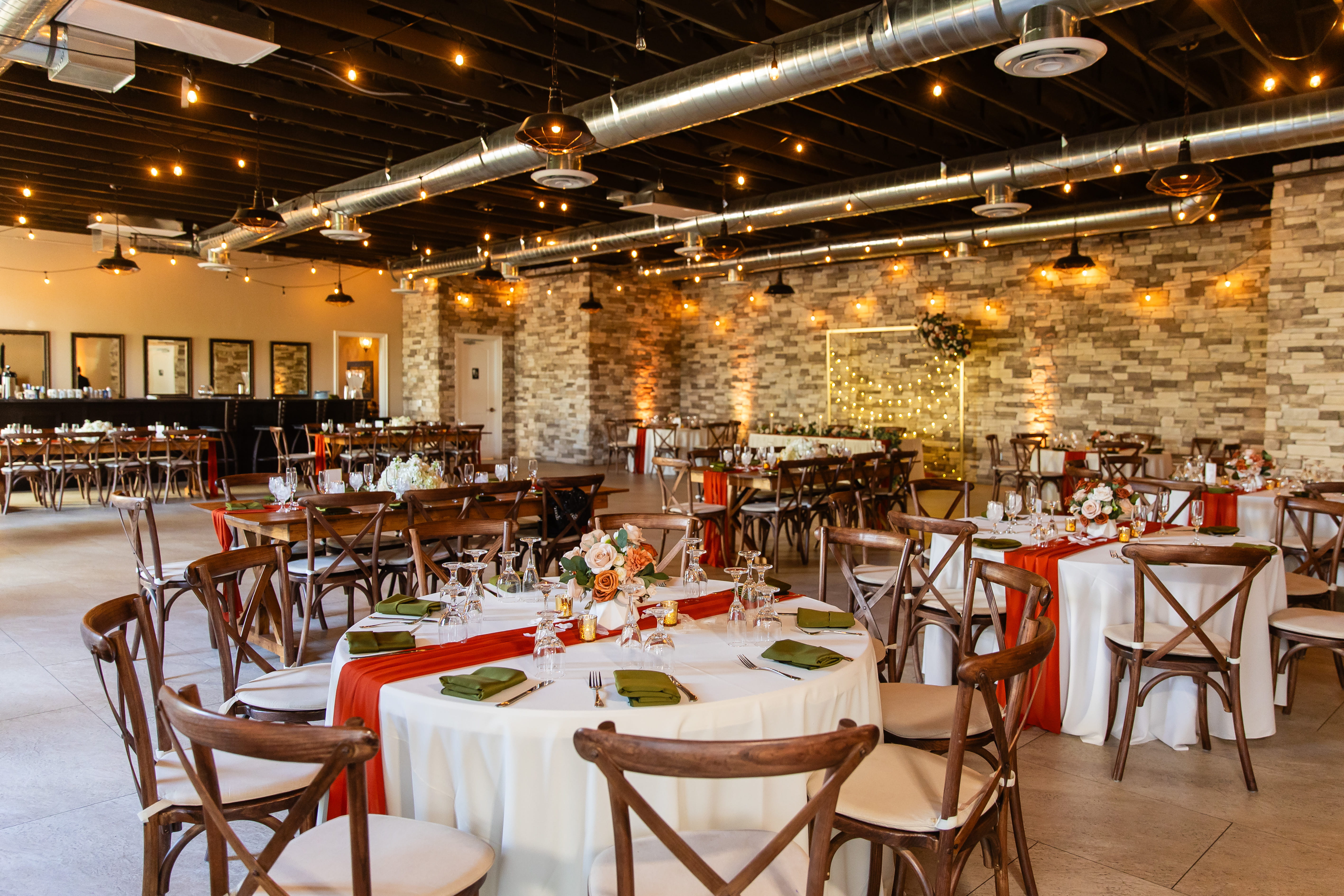 The Cellar indoor wedding venue Las Vegas featuring modern reception layout with wood tables and soft uplighting 