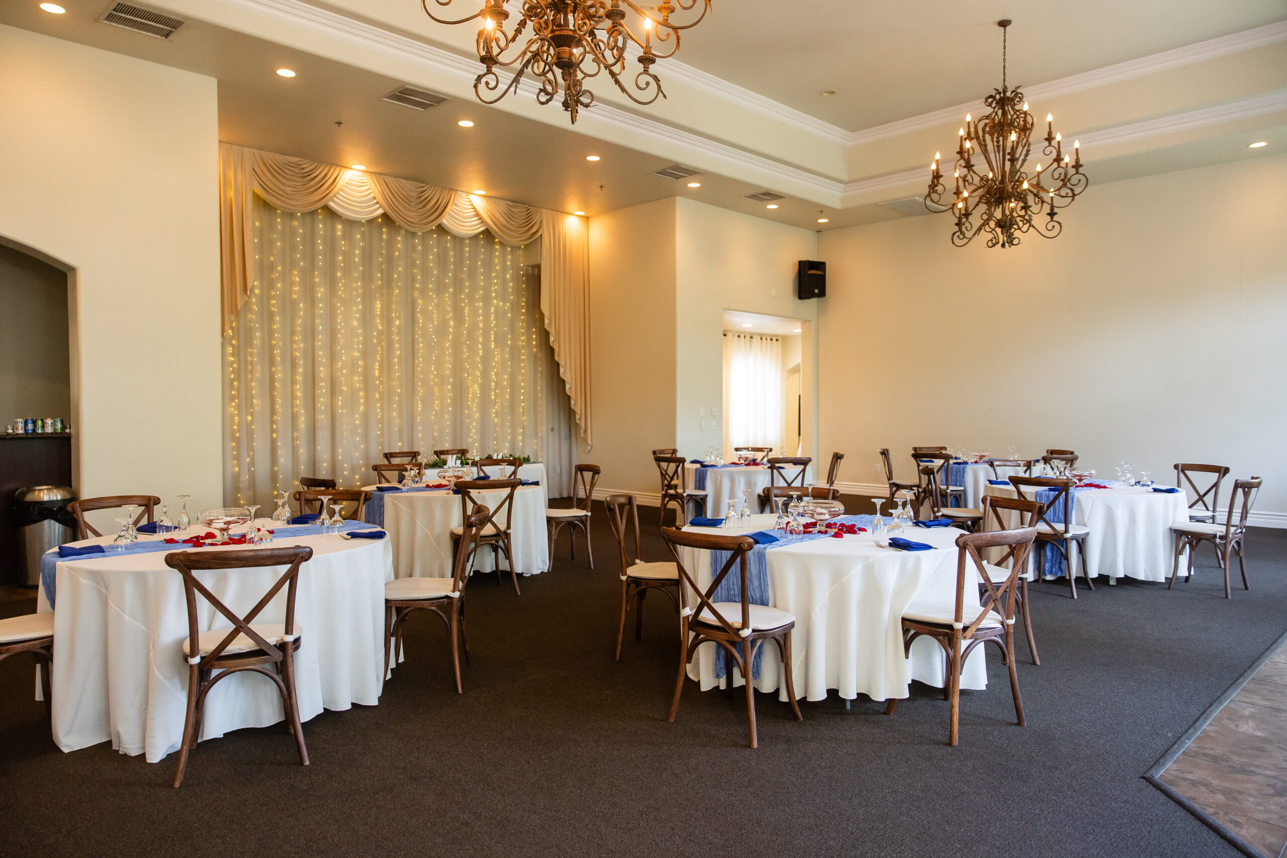 Intimate wedding reception space with soft lighting, round tables, and decorative backdrop inside The Sunset Room Las Vegas