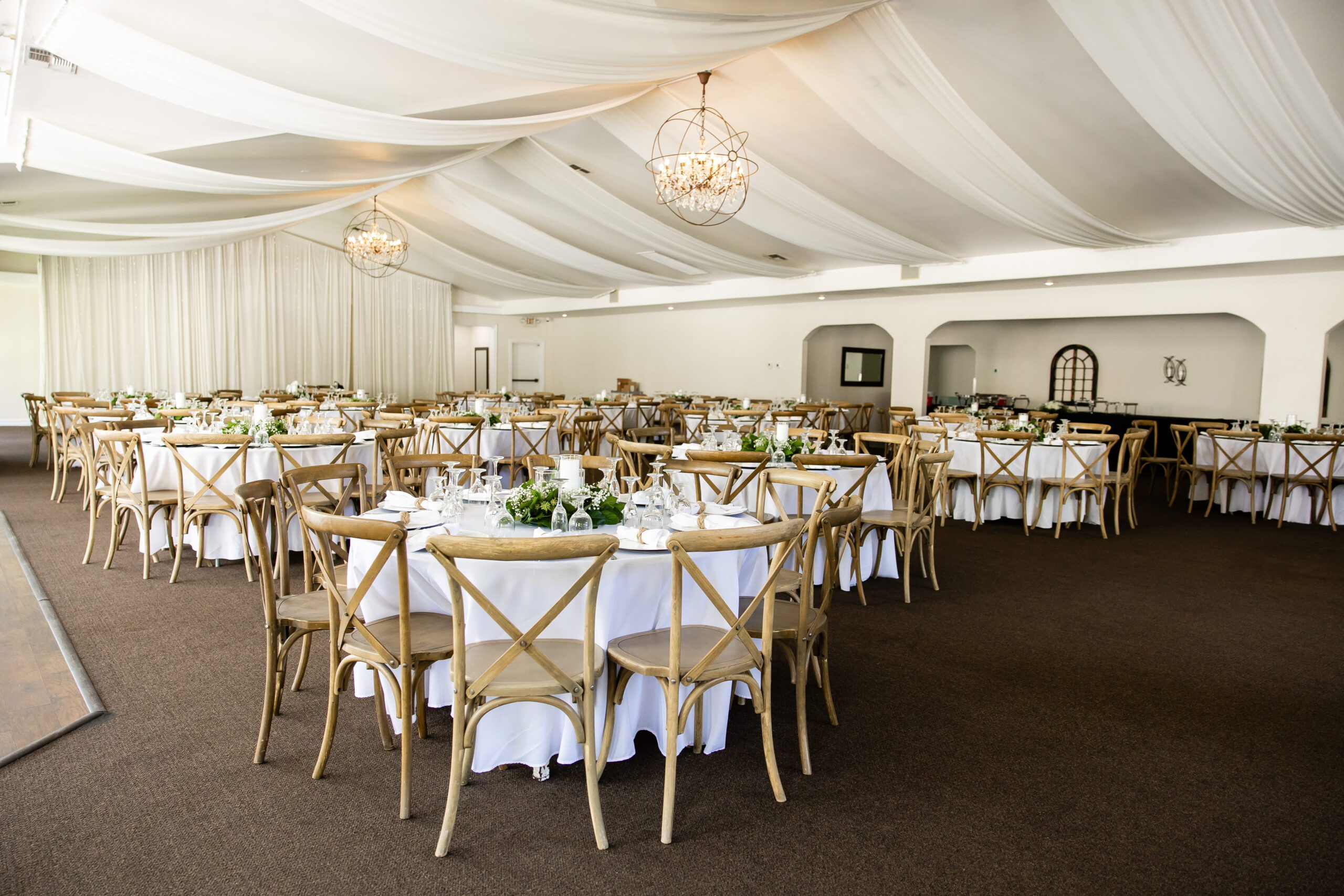 Wedding reception setup with wooden chairs in Garden Room Las Vegas