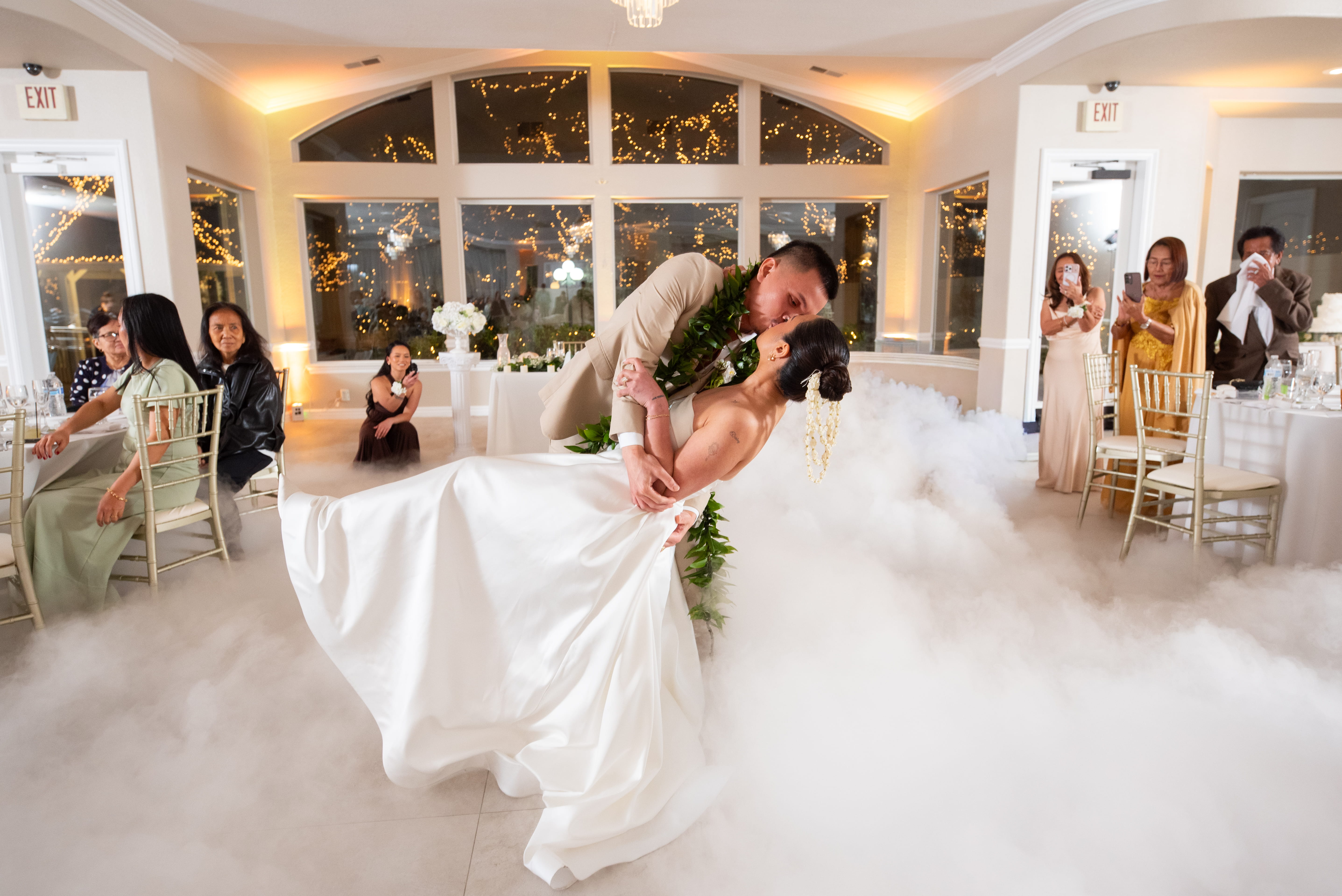 Bride and groom first dance with dramatic fog effect during a lively Las Vegas wedding reception