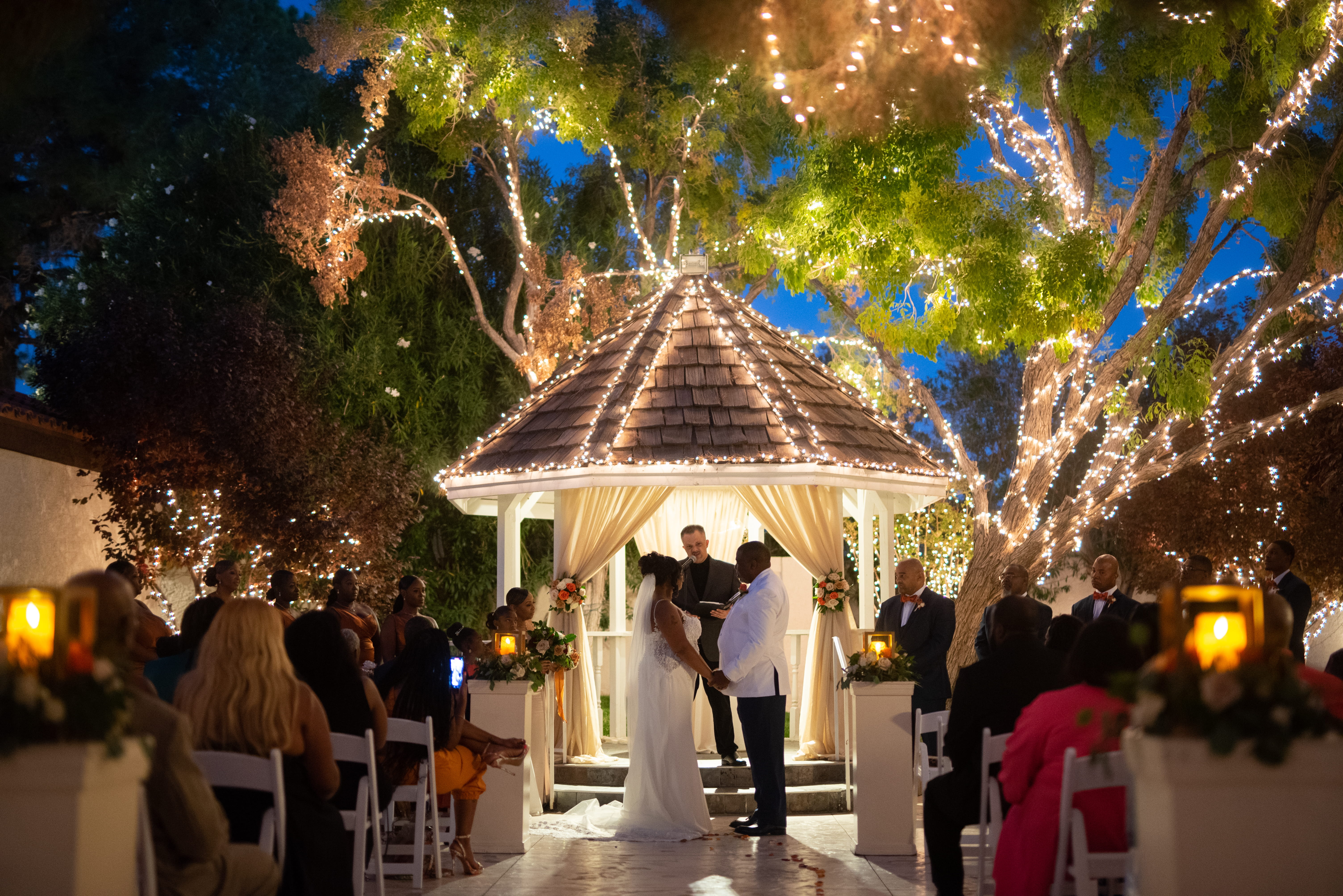 Evening wedding ceremony under lit gazebo at outdoor ceremony wedding venue Las Vegas