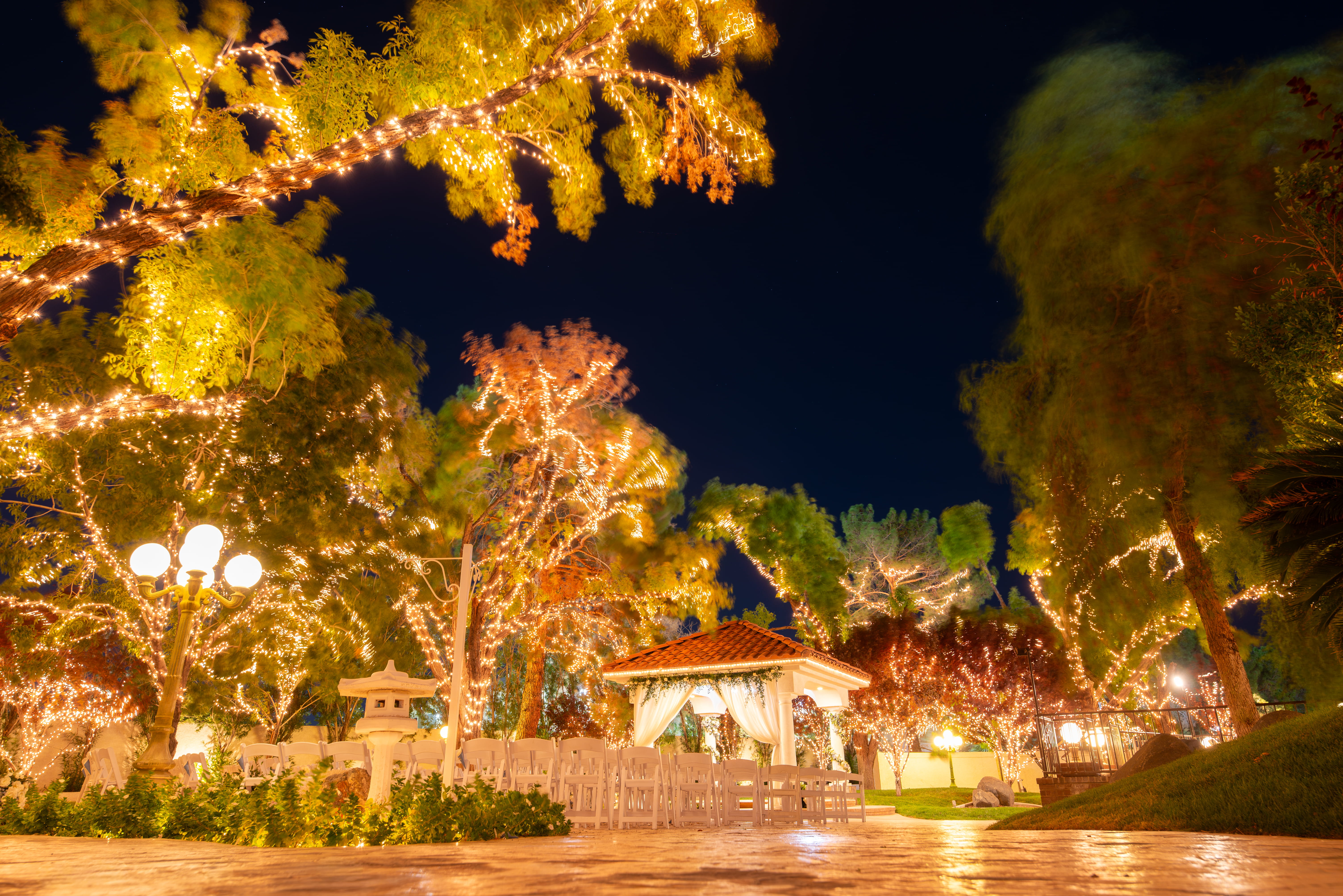Garden Pavilion ceremony area lit with string lights at Las Vegas garden wedding venue