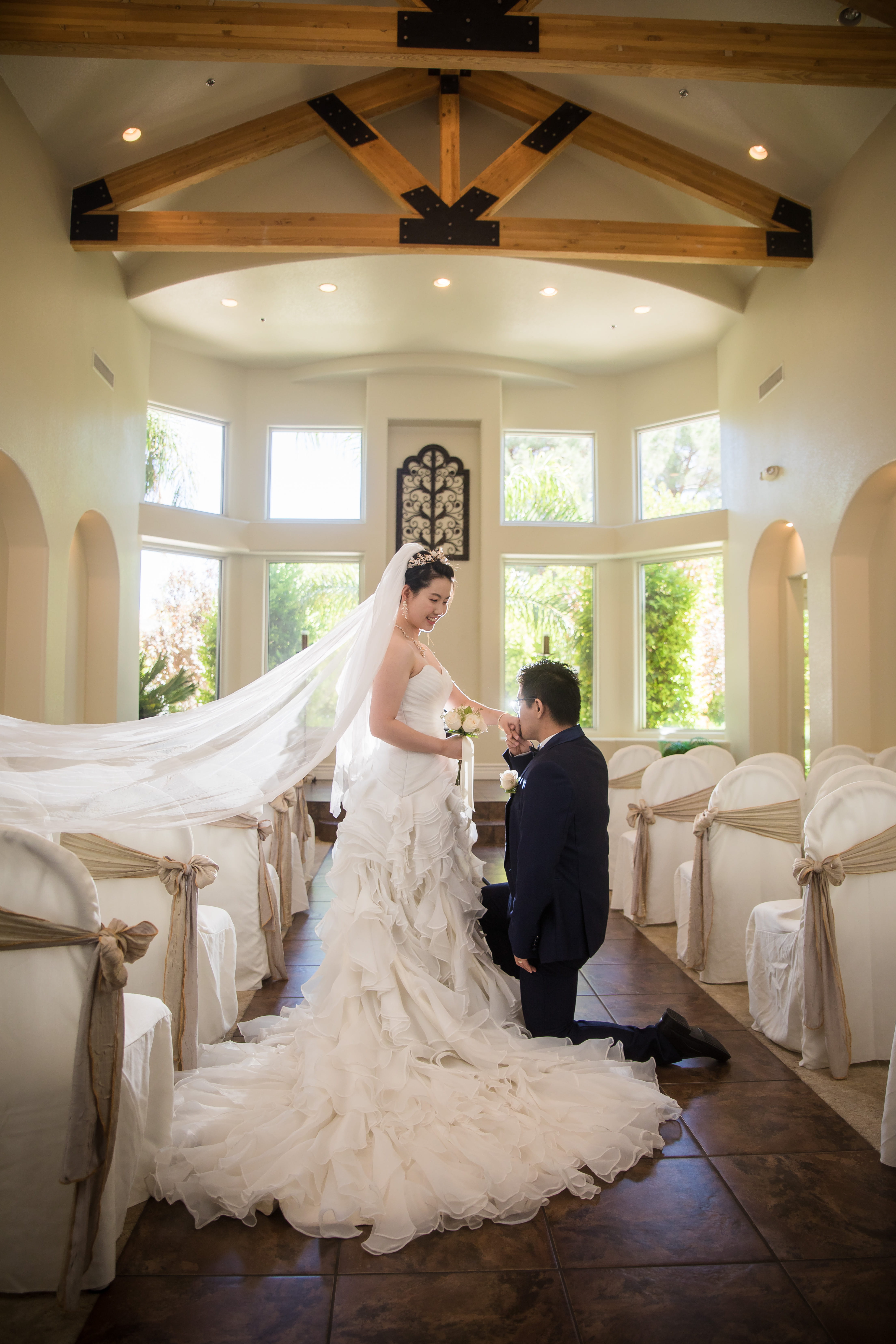 Bride and groom sharing a romantic moment inside a bright Las Vegas wedding chapel with wooden beams