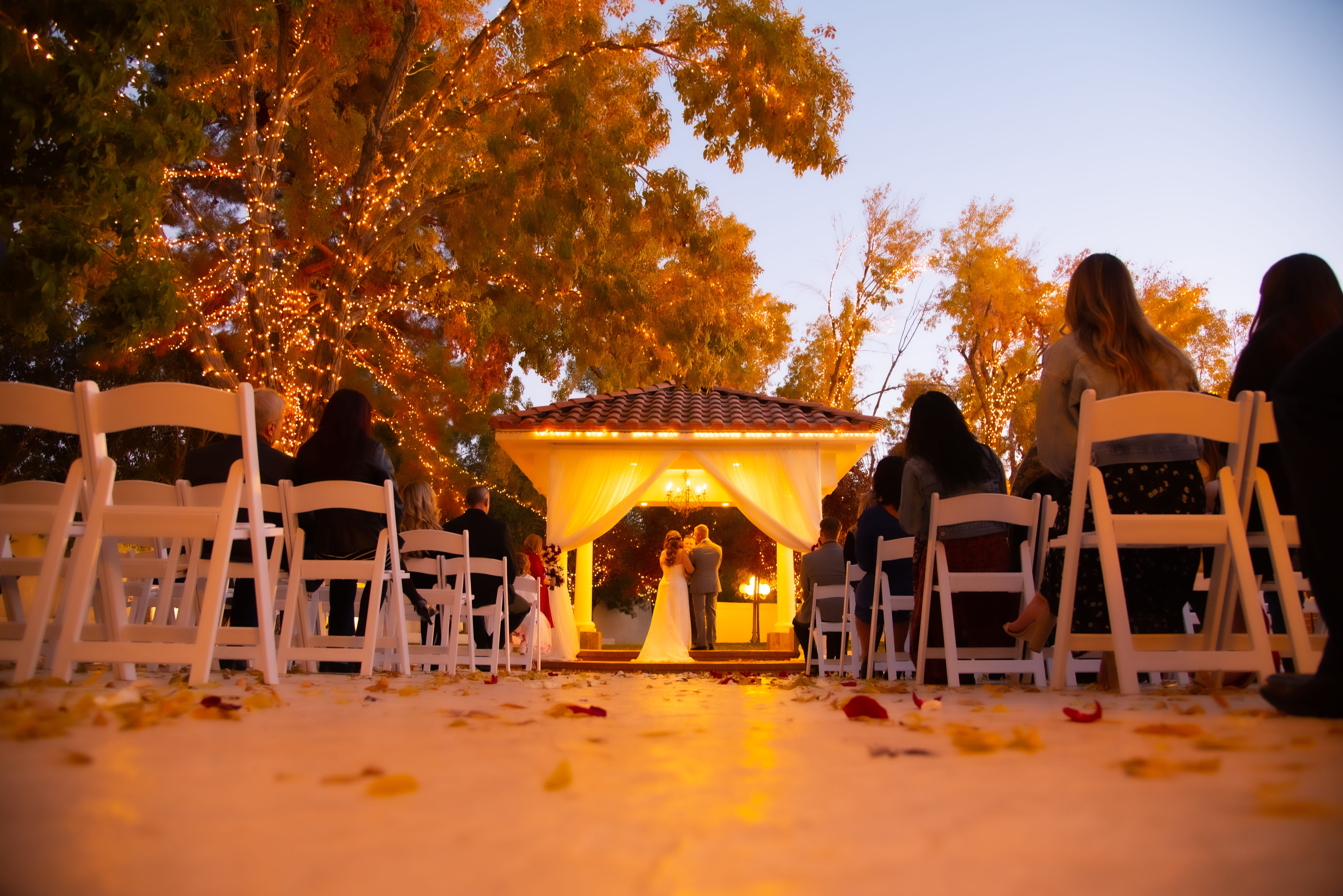 Evening garden ceremony setup with gazebo at Las Vegas outdoor wedding venue